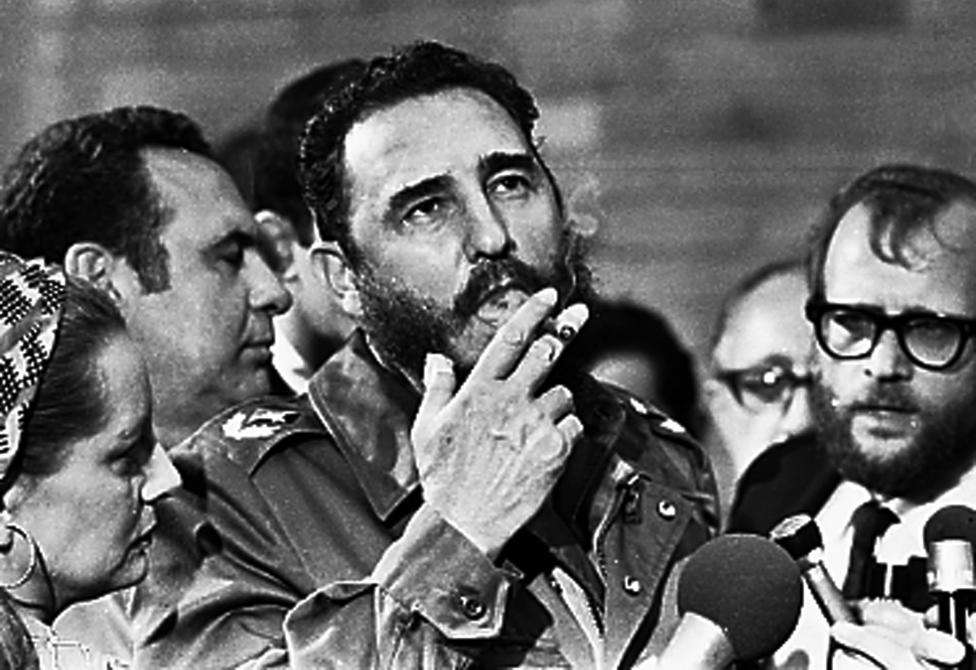 Fidel Castro smokes a cigar during interviews with the press in Havana during a visit of U.S. Senator Charles McGovern in May 1975. 