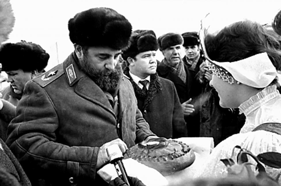 Fidel Castro breaks a piece of bread offered to him before the XXVI Congress of the Soviet Union