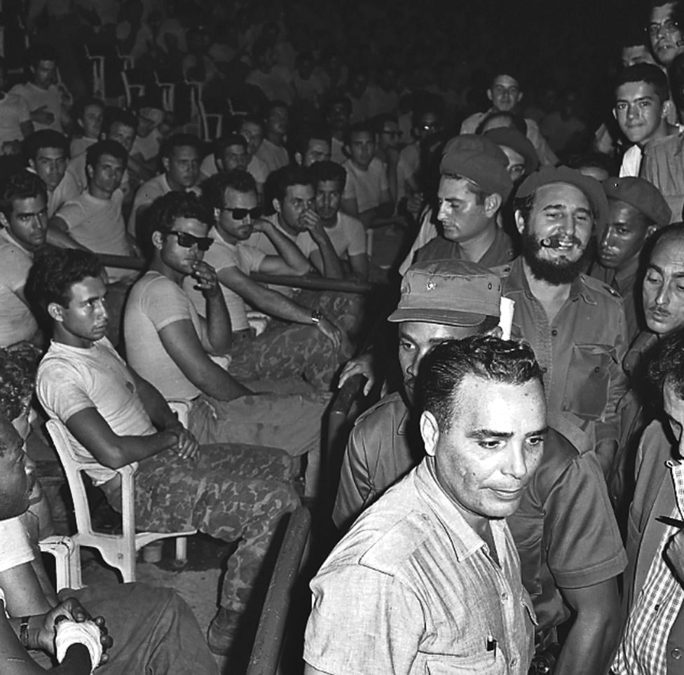Fidel Castro (3rd row, R) enters a public trial for captured members (seated) of the failed Bay of Pigs invasion in Havana in April 1961.