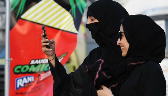 Most women at the event wore traditional black robes and head covers