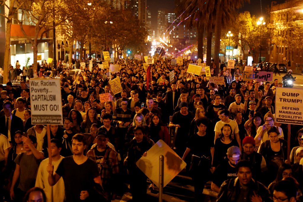 Demonstrators march on Market Street in San Francisco, California, U.S. following the election of Donald Trump as the president of the United States November 9, 2016. REUTERS