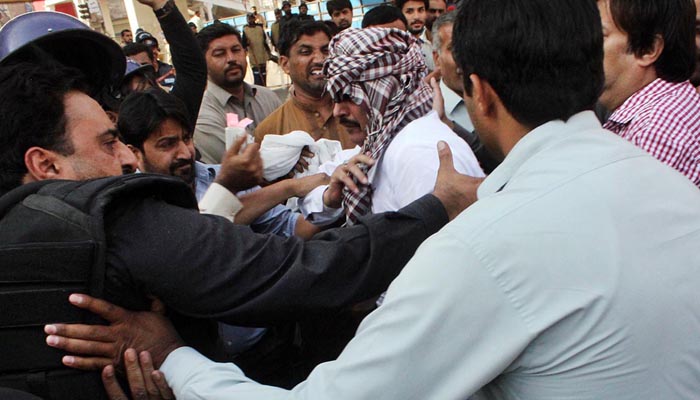  Policemen arresting MPA Ijaz Khan Jazi during public gathering of Awami Muslim League at Committee Chowk.