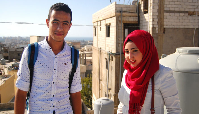 Mustapha Dakhloul, left, and Amal Said on a rooftop in Burj al-Shamali, one of the spots from which they flew a balloon over the camp [Jillian Kestler-D