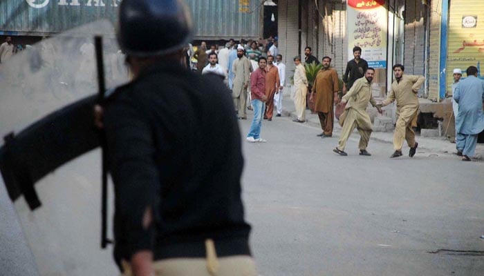  Activists of political parties seen throwing stone towards policemen during a public gathering of Awami Muslim League at Committee Chowk.