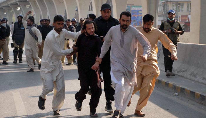 Policemen in plain clothes seen arresting activist of a political party to avoid public gathering at Committee Chowk