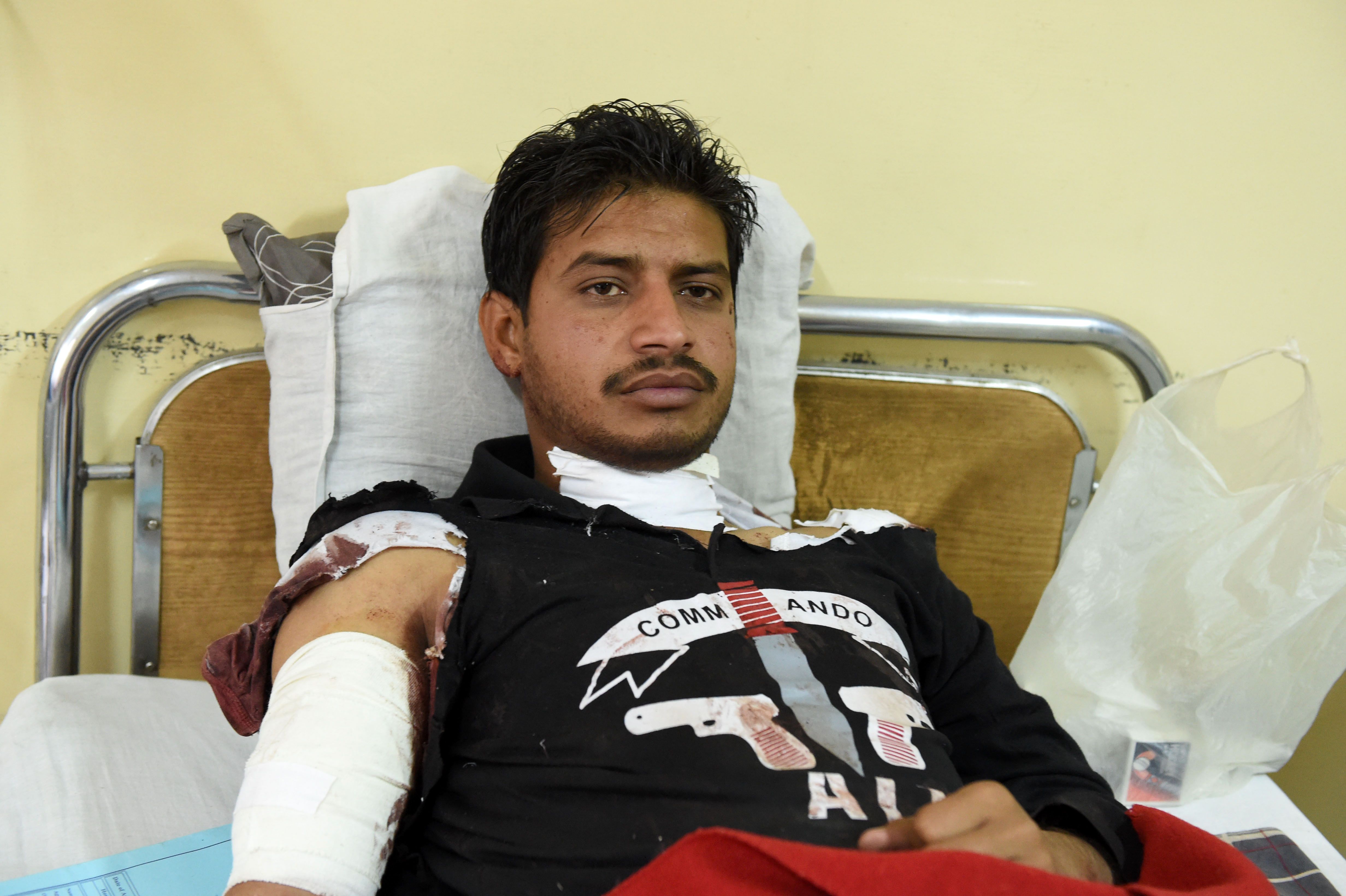 An injured policeman rests on a hospital bed in Quetta on October 25, 2016, after an overnight militant attack on the Police Training College Balochistan.