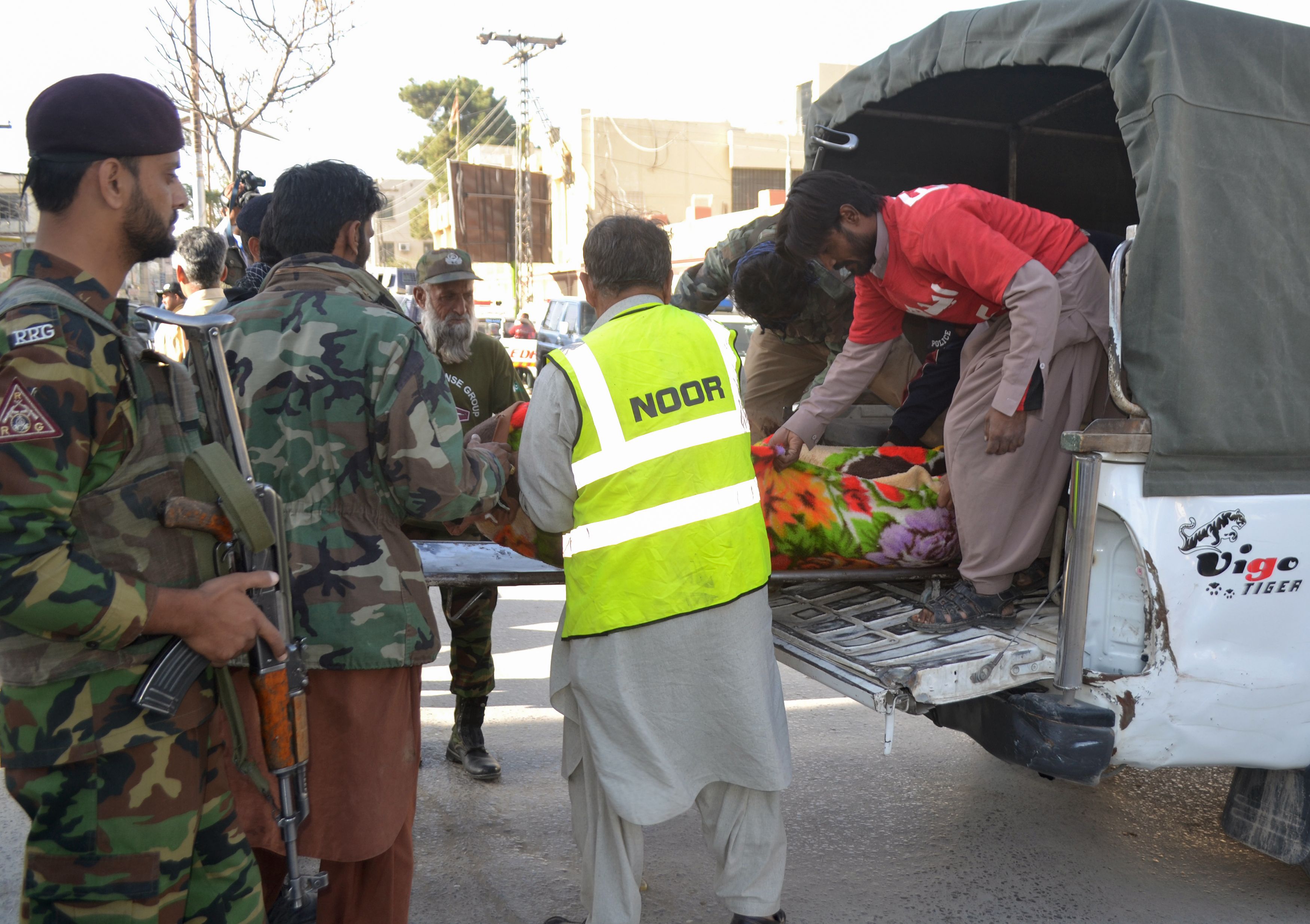 Security personnel transport an injured man in Quetta on October 25, 2016, after militants attacked a police academy.