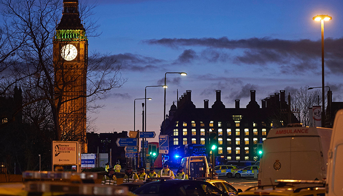 British police officers work on Westminster Bridge, adjacent to the Houses of Parliament