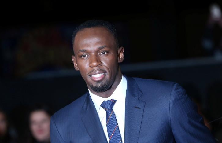 Athlete Usain Bolt (C) poses for photographers at the world premiere of the film 