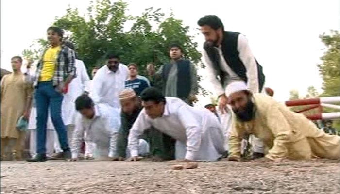 Workers warm-up early morning at Bani Gala