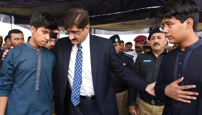 Photo from Nov 28, 2016 shows Shindh Chief Minister Murad Ali Shah consoling the sons of slain DSP Fazi Ali Shaigri