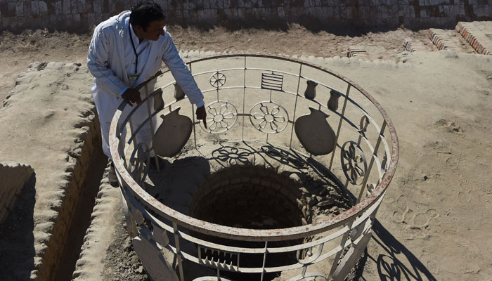 A caretaker at the UNESCO World Heritage archeological site of Mohen jo Daro, Ismail Mugheri, points out a well. PHOTO: AFP