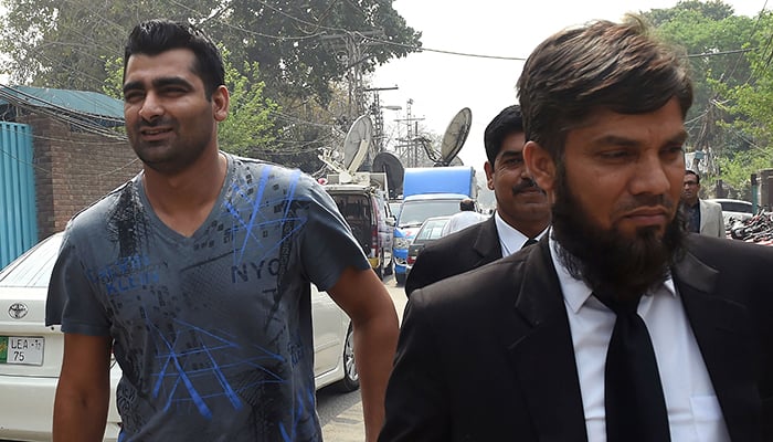 Shahzaib Hasan (L) arrives with his lawyer at FIA  to record his statement in Lahore on March 21, 2017 – AFP 