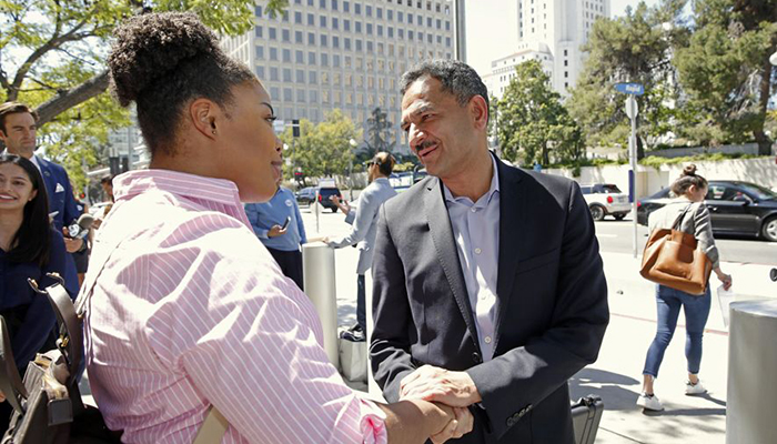 Dr Asif Mahmood, right, a physician who came to the US from Pakistan, greets supporters as he announces he is joining the 2018 race for California’s lieutenant governor - AP