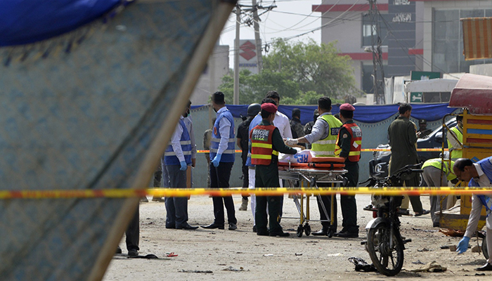 Pakistani security officials collect evidence from the scene of a suicide bomb attack on a census team in Lahore – AFP 