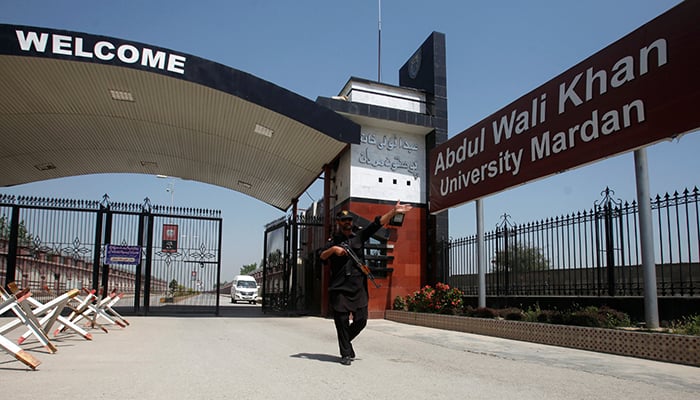 A policeman gestures as he stands at the entry of Abdul Wali Khan University where Mashal Khan was killed on Thursday – Reuters 