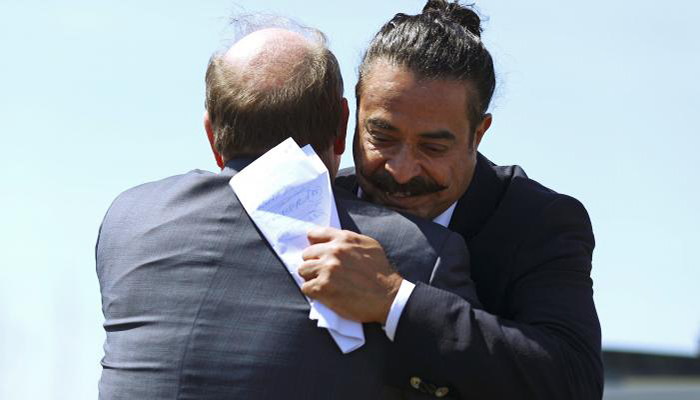 Flex-N-Gate owner and businessman Shahid Khan (R), embraces Detroit Mayor Mike Duggan before speaking during a groundbreaking ceremony for a Flex-N-Gate manufacturing facility in the I-94 Industrial Park in Detroit, Michigan, US - REUTERS