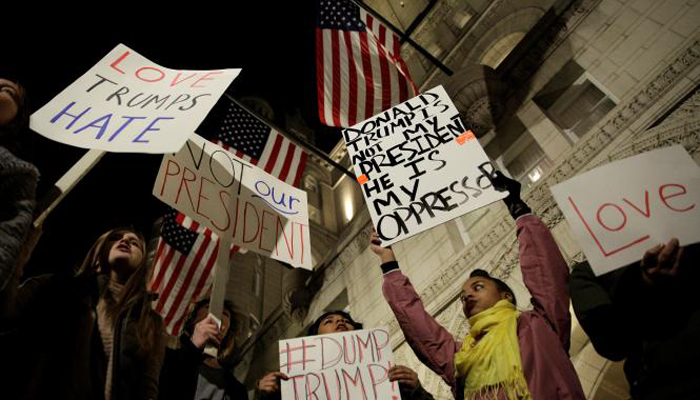 null Demonstrators protest against U.S. President-elect Donald Trump in front of the Trump International Hotel in Washington, US- REUTERS