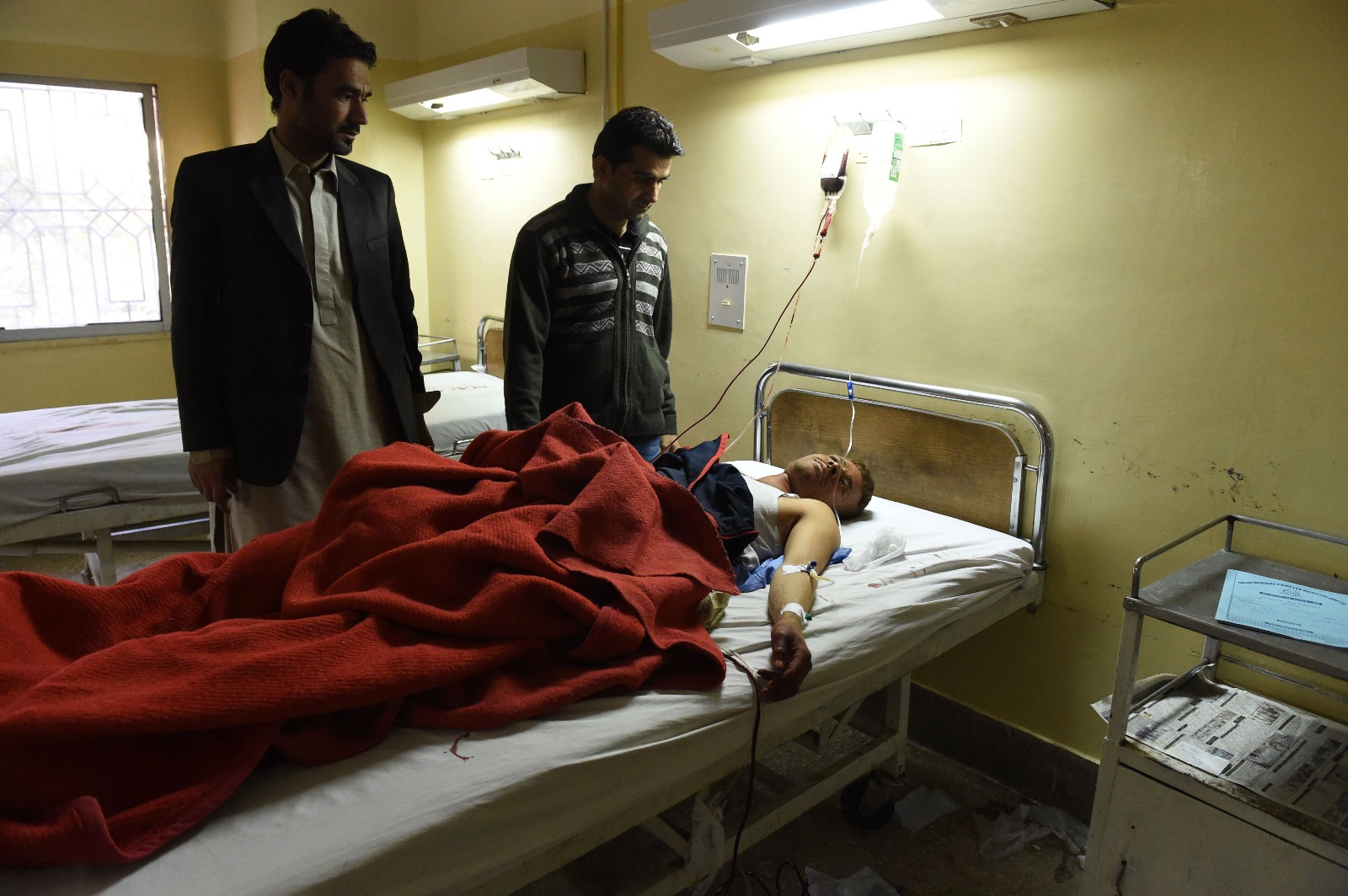 Men take care of an injured relative at a hospital in Quetta.