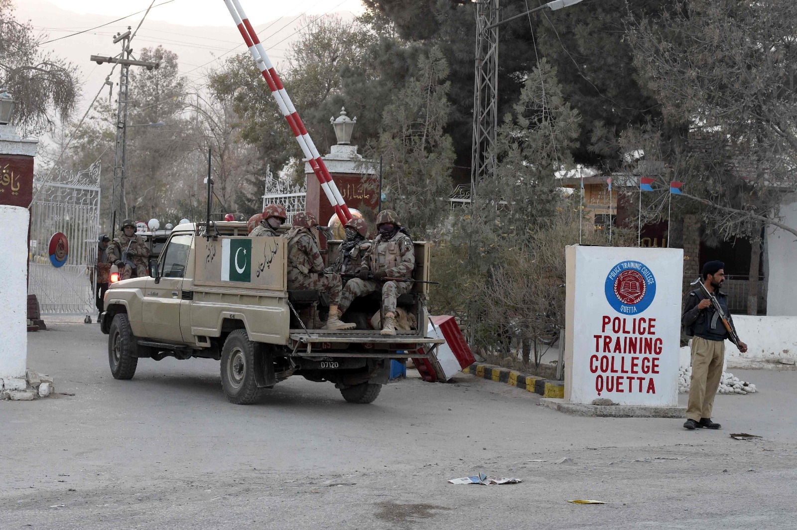 Pakistani soldiers pass through the entrance to The Police Training College in Quetta.