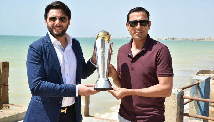 Shahid Afridi and Younis Khan pose with the Champions Trophy at Hawke