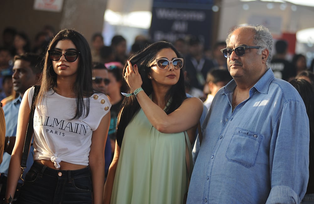 Indian Bollywood actress Sridevi (C) poses with her daughter (L) and husband Boney Kapoor (R) as they arrive to attend a concert performance by Canada´s Justin Bieber at The D.Y. Patil Stadium in Navi Mumbai on May 10, 2017. / AFP / Sujit JAISWAL