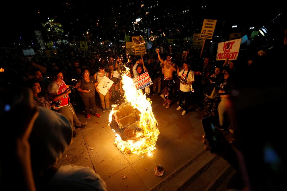A Donald Trump pinata is burned in downtown Los Angeles.