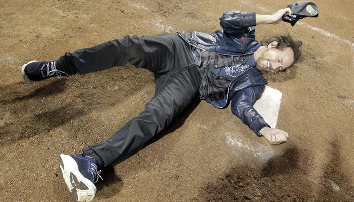 Recording artist Eddie Vedder celebrates on home plate after the Chicago Cubs win. 
