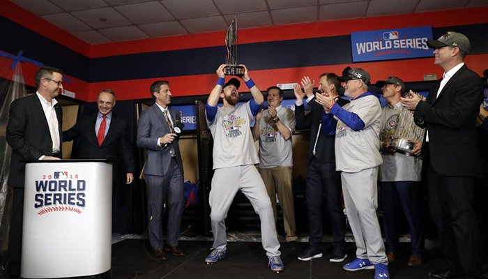 Chicago Cubs outfielder Ben Zobrist celebrates with the MVP trophy.