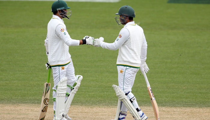 Sami Aslam and Azhar Ali touch gloves during their partnership stand / AFP