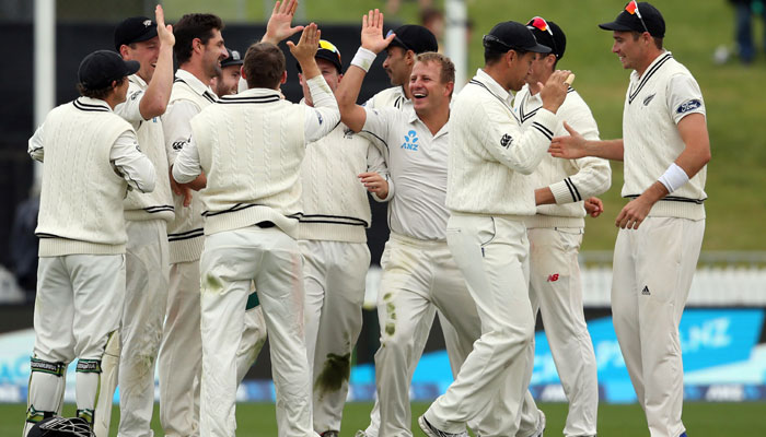 NZ celebrate a wicket during day five of the second Test / AFP