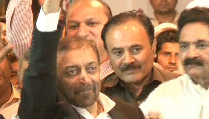 Sattar waves at his supporters after he was released from police detention