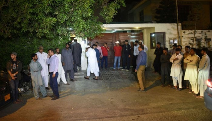 Pakistani people gather outside the house of Junaid Jamshed, a former Pakistani pop star turned evangelical Muslim, in Karachi on December 7, 2016, after his death in plane crash -AFP