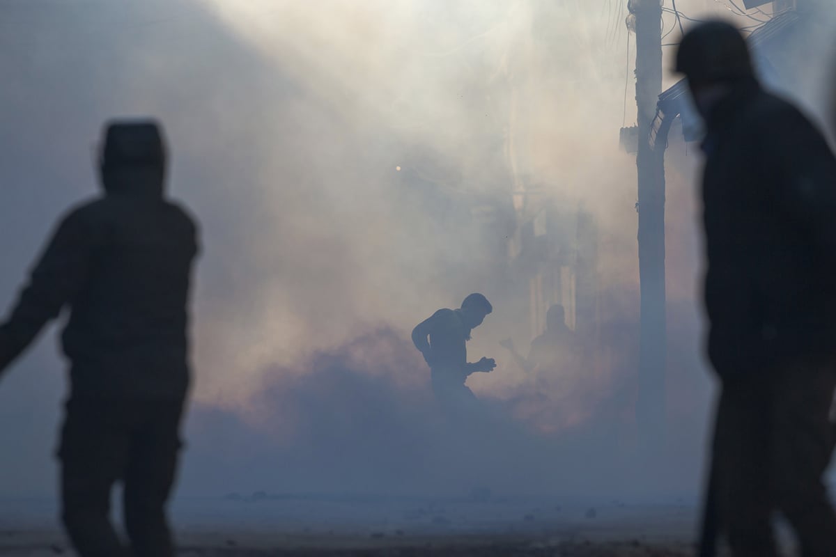 Tear gas smoke engulfs a Kashmiri protester in Srinagar on February 10, 2017.—AP Photo