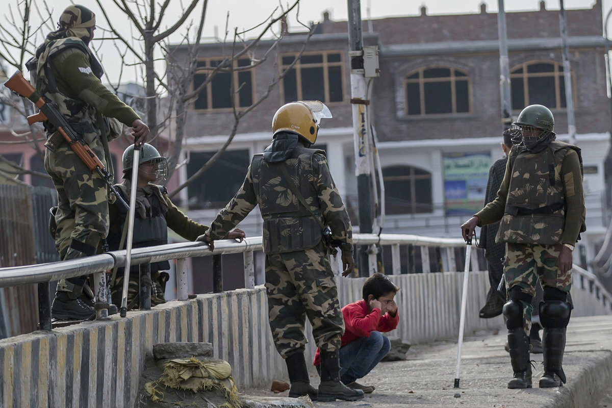 In this March 29, 2017, photo, Indian paramilitary soldiers force a Kashmiri child to perform sit-ups while holding his ear lobes before letting him go during a strike in Srinagar.—AP Photo