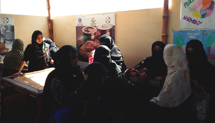 Women sitting, enjoying tea and talking to each other