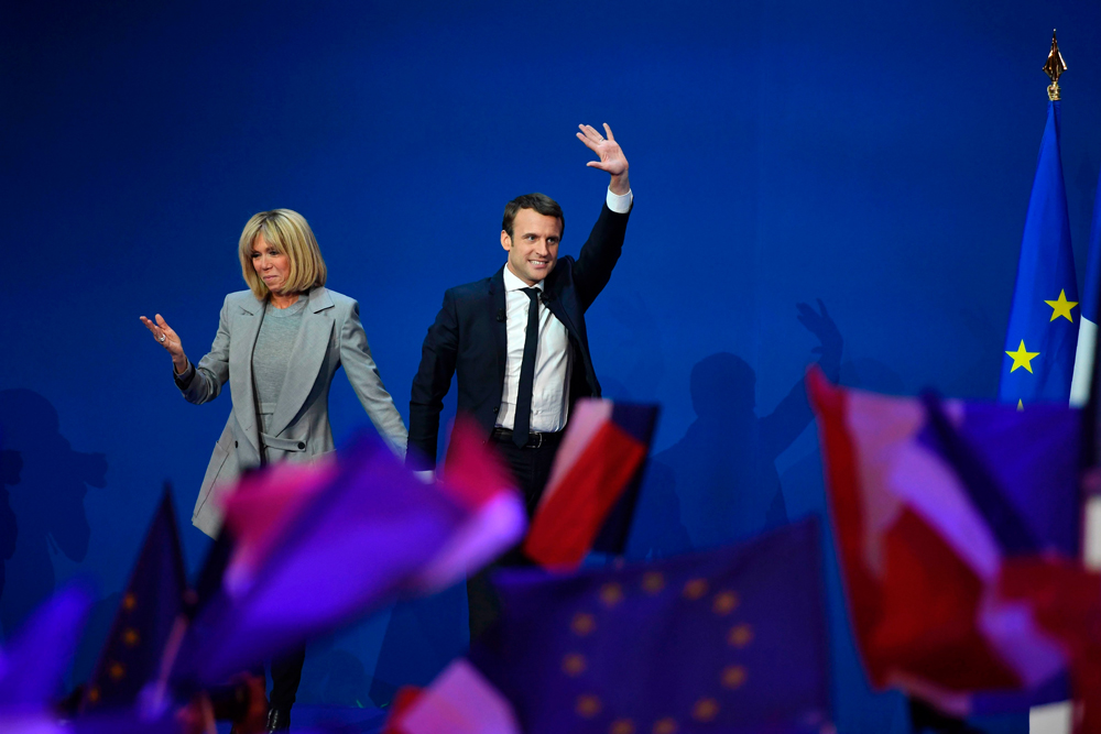 This file photo taken on April 23, 2017 shows   French presidential election candidate for the En   Marche ! movement Emmanuel Macron and his wife   Brigitte Trogneux arriving on stage at the Parc   des Expositions in Paris, after the first round   of the Presidential election. AFP / Eric   FEFERBERG