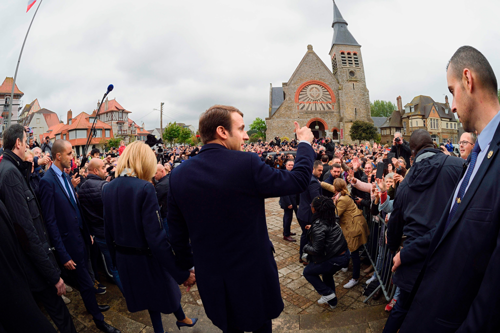 French presidential election candidate for the En   Marche ! movement Emmanuel Macron waves to   supporters after voting in Le Touquet, northern   France, on May 7, 2017, during the second round   of the French presidential election. / AFP / Eric   FEFERBERG