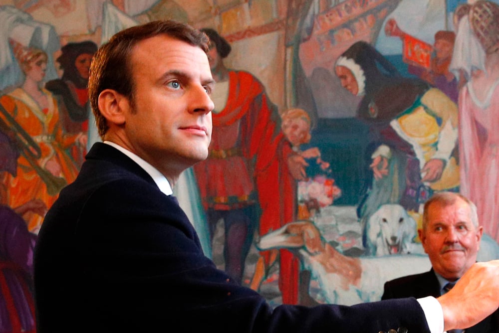 French presidential election candidate for the En   Marche ! movement Emmanuel Macron casts his   ballot at a polling station in Le Touquet,   northern France, on May 7, 2017, during the   second round of the French presidential election.   / AFP / POOL / Christophe Ena