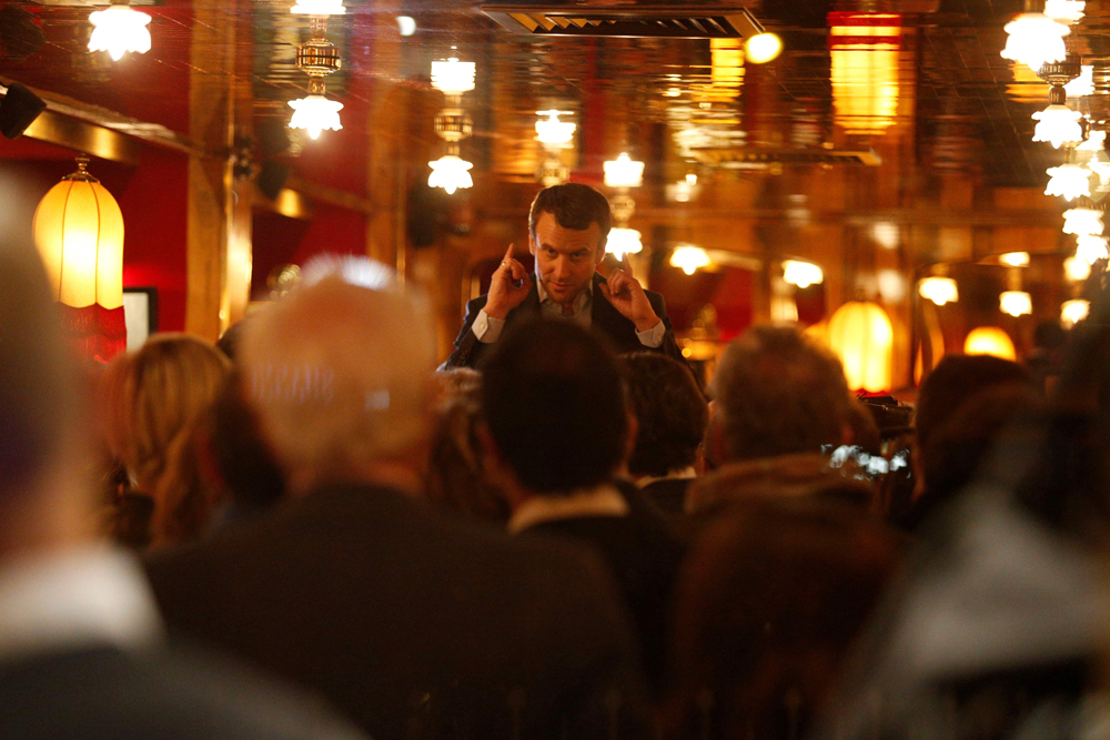 This file photo taken on April 23, 2017 at La   Rotonde restaurant in Paris, shows French   presidential election candidate for the En Marche   ! movement Emmanuel Macron meeting some of his   supporters after the first round of the   Presidential election. French voters will chose   on May 7, 2017 between Pro-European centrist   Macron and far-right rival, who have offered   starkly different visions for France during a   campaign closely watched in Europe and the rest   of the world. / AFP / GEOFFROY VAN DER HASSELT