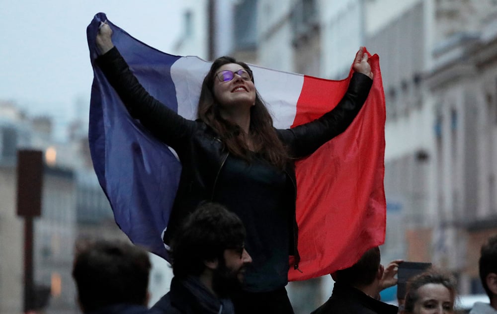 A supporter of President Elect Emmanuel Macron   celebrates in Paris, France, May 7, 2017.   REUTERS/Eric Gaillard