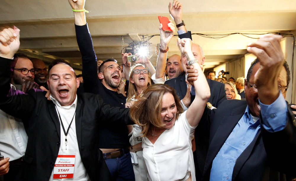 Supporters of French President-elect Emmanuel   Macron, head of the political movement En Marche   !, or Onwards !, react after announcement in the   second round of 2017 French presidential election   at En Marche local headquarters in Marseille,   France, May 7, 2017. REUTERS/Philippe Laurenson