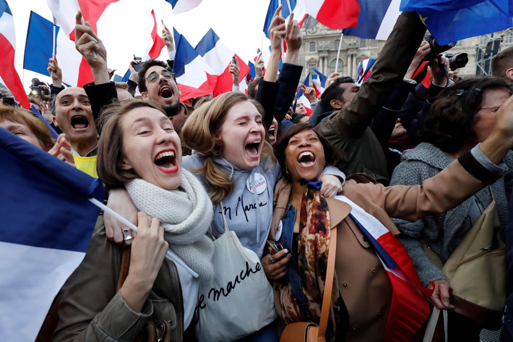 Supporters of French president-elect Emmanuel   Macron react at the Louvre Museum in Paris on May   7, 2017, after the second round of the French   presidential election. AFP / Patrick KOVARIK