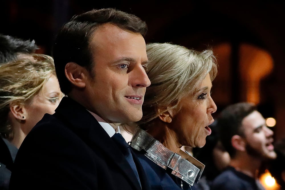 French president-elect Emmanuel Macron (C) and   his wife Brigitte Trogneux (R) sing the nationl   anthem after he delivered a speech in front of   the Pyramid at the Louvre Museum in Paris on May   7, 2017, after the second round of the French   presidential election. AFP / POOL / THOMAS SAMSON