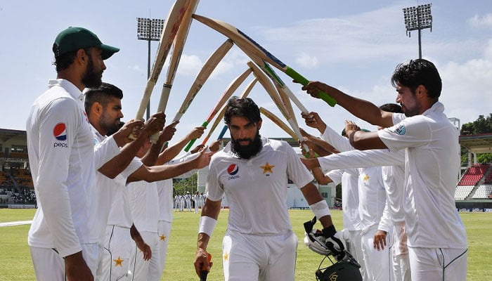 Misbah walks off to a guard of honour after his last innings/AFP