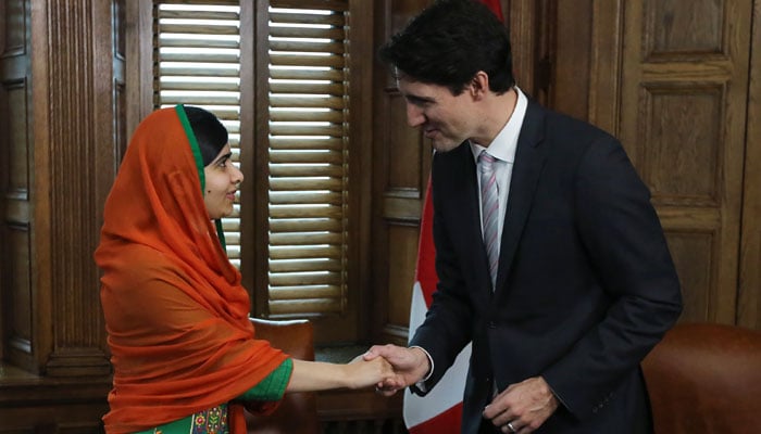 Malala Yousafzai shakes hands with Canadian Prime Minister Justin Trudeau on Parliament Hill in Ottawa, Ontario on April 12, 2017/AFP