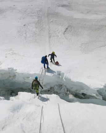 Climbers cross a part of Khumbu Icefall using a ladder at Everest April 28, 2016. Phurba Tenjing Sherpa/Handout via