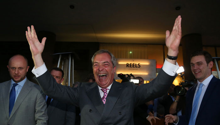 Leader of the United Kingdom Independence Party (UKIP), Nigel Farage (C) reacts outside the Leave.EU referendum party at Millbank Tower in central London- AFP
