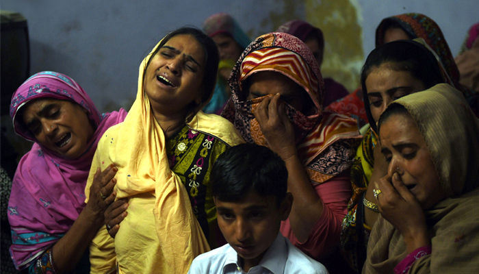 A Pakistani mother (2L) mourns along with others over the coffin of her son, 13-year-old blast victim Zeeshan, during his funeral in the town of Sehwan in Sindh province. AFP / ASIF HASSAN 
