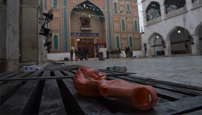 A doll lies on the ground at the 13th century shrine of Muslim Sufi Lal Shahbaz Qalandar a day after the bomb attack. AFP/ASIF HASSAN